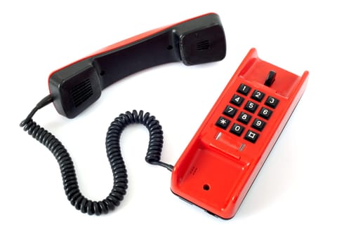 Old red telephone isolated on white background
