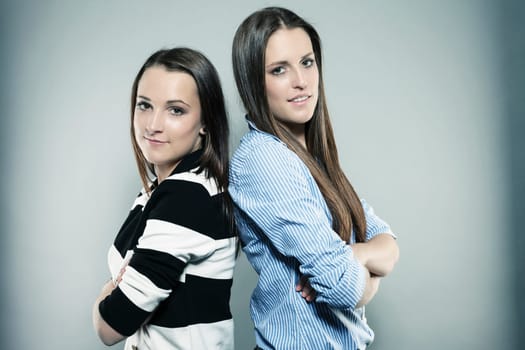 Portrait of two teenagers with crossed arms