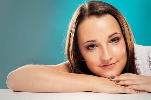 Portrait of a teenager in front of a green background