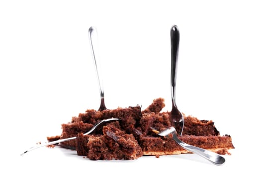 Destroyed chocolate cake with four forks