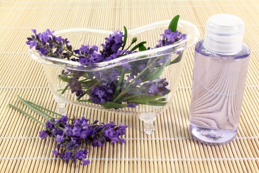 a tub with lavender flowers and lavender oil