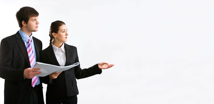 Image of two business people holding a document and looking at something