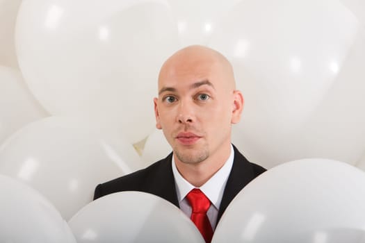 Image of handsome businessman inside white balloons