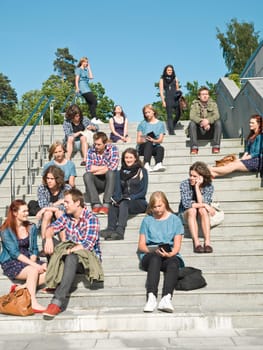 Large group of people sitting in the stairs