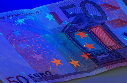 Fifty euro note under ultraviolet light