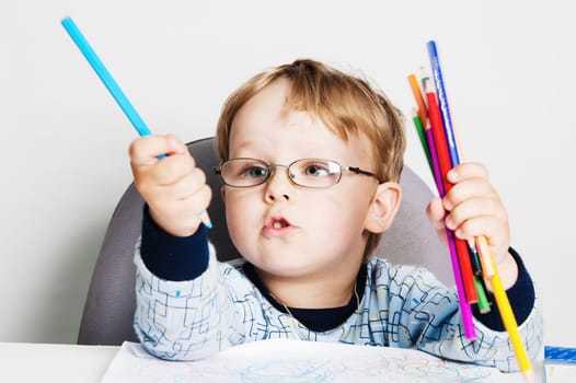 Portrait of the little boy with pencils