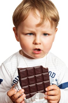 The little boy eats chocolate