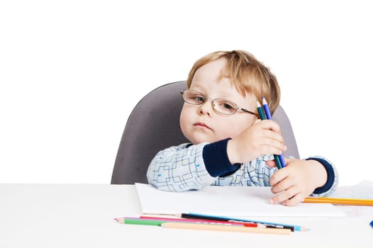 Portrait of the little boy with pencils