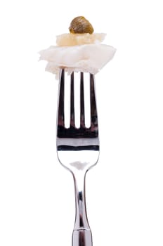 Isolated zander with lemon and caper on a fork