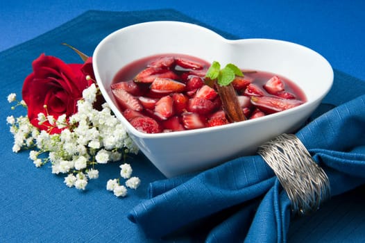 strawberries with red wine, cinnamon and brown sugar on a colore