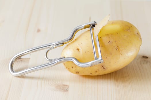 Potato with potato peeler