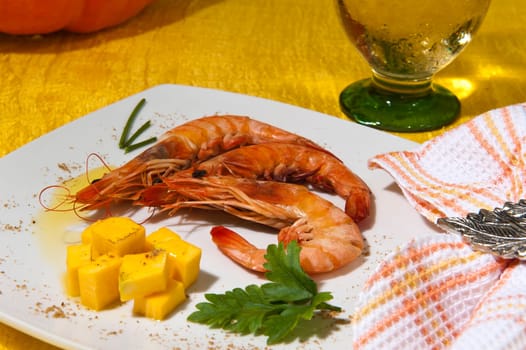 shrimp and cubes of pumpkin on black background