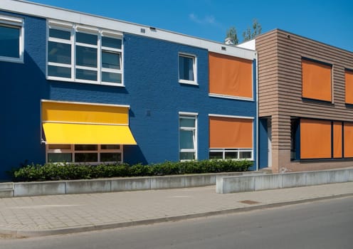 modern building with yellow and orange sunshades on a hot day