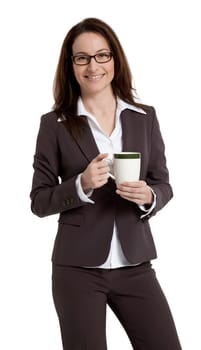 Pretty business woman standing, holding coffee mug, isolated on white.