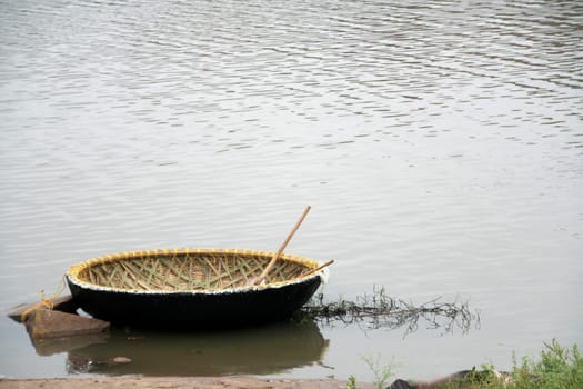 Newly built coracle along with row stick