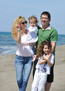 happy young family have fun and live healthy lifestyle on beach