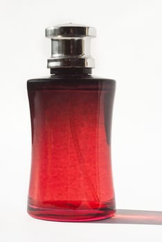 men&#039 s perfume in beautiful red bottle isolated on white