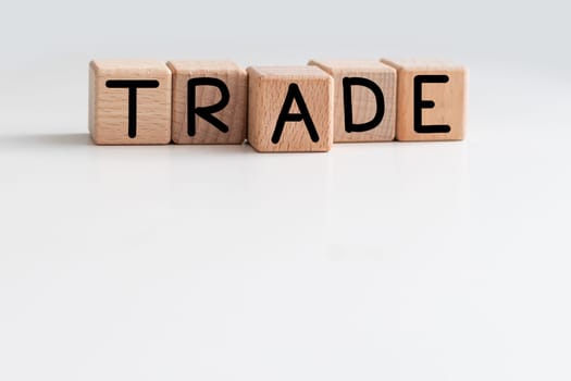 Trade symbol. Wooden cubes with word Trade. Beautiful white background. Trade concept. Copy space. High quality photo