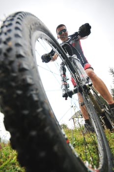 healthy lifestyle and fitness concept with mount bike man outdoor