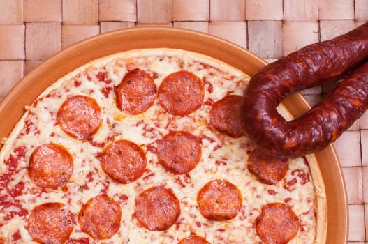 Pizza picante with spicy salami sausage,cheese and tomatoes