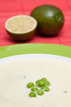 Green peas in a pea cream soup in a plate