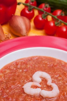 Three shrimps in a cold vegetable soup Gazpacho