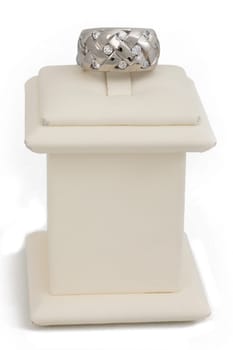 Woven ring with diamonds on display stand