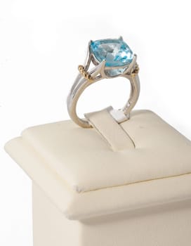 Ring with blue stone on display stand
