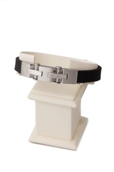Silver and black bracelet on display stand