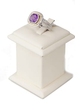 Ring with purple stone on display stand