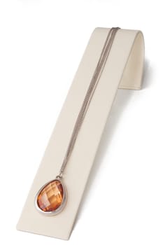 Yellow-red crystal pendant necklace on display stand
