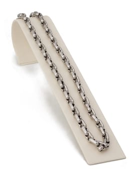 Silver linked chain necklace on display stand