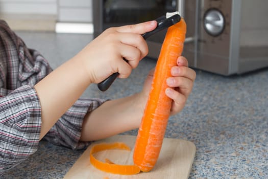 Child peeling carrots