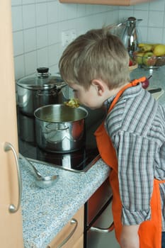Boy cooking soup