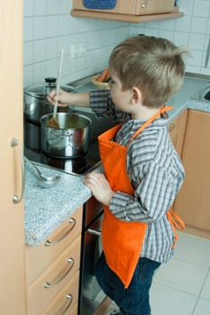 Boy cooking soup