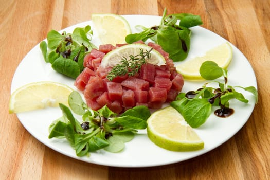 tuna tartare with fresh salad and lemon slice