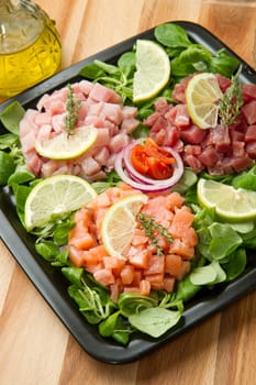 salmon, tuna and swordfish tartar with fresh salad