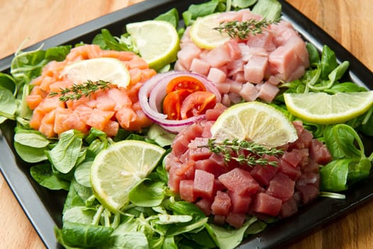 salmon, tuna and swordfish tartare with fresh salad