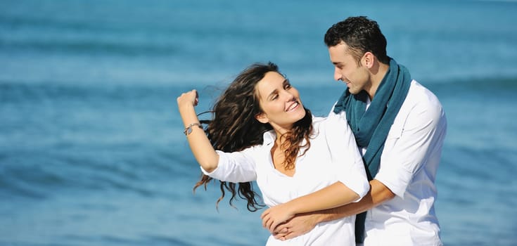 happy young couple in white clothing  have romantic recreation and   fun at beautiful beach on  vacations