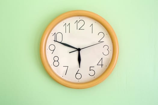 Clock hanging on wall and showing current time