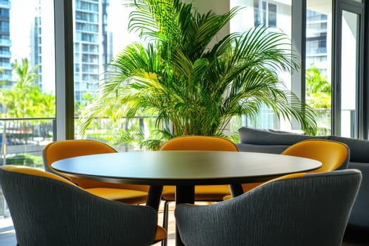 Discover a modern workspace featuring a round table and stylish chairs, surrounded by lush greenery and natural light, perfect for summer vibes and creativity.