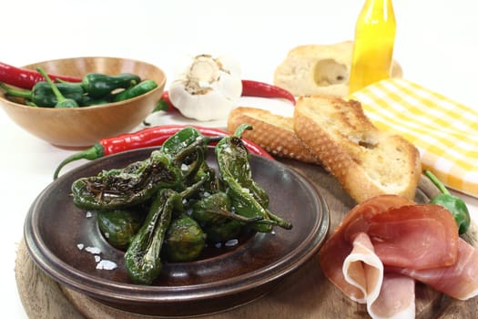 fried pimentos with ham and baguette