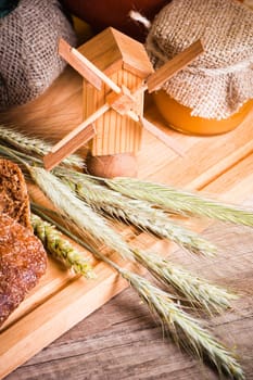 sliced bread and wheat on the wooden table
