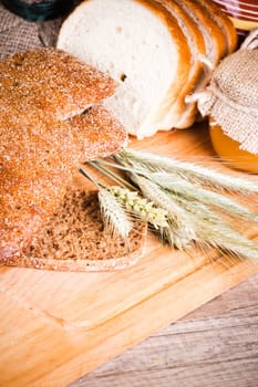 sliced bread and wheat on the wooden table