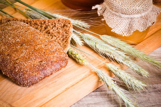 sliced bread and wheat on the wooden table