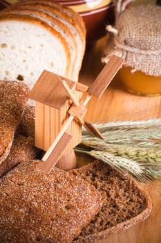sliced bread and wheat on the wooden table