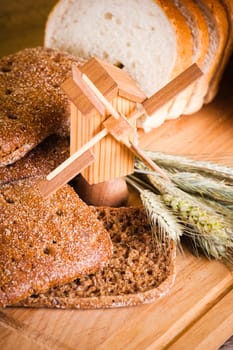 sliced bread and wheat on the wooden table