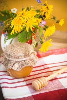 Still life with honeycombs, flowers and pot