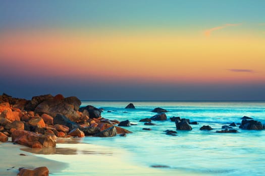 Sunset over the sea. Stone on the foreground