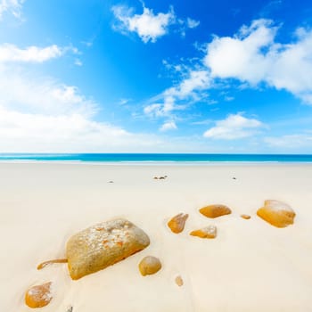 Sandy tropical beach. Stone on the foreground